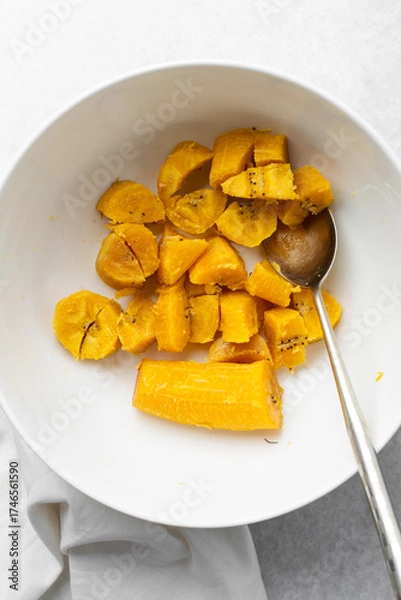 Fototapeta overhead view of Boiled ripe plantain in a white bowl, top view of nigerian cooked ripe plantain