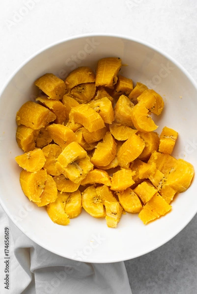 Fototapeta overhead view of Boiled ripe plantain in a white bowl, top view of nigerian cooked ripe plantain