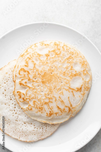 Fototapeta Overhead view of a plate of sinasir, top view of food from northern nigeria sinasir rice pancake