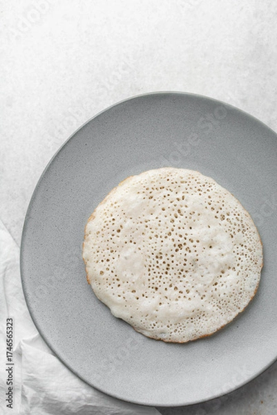 Fototapeta Overhead view of a plate of sinasir, top view of food from northern nigeria sinasir rice pancake