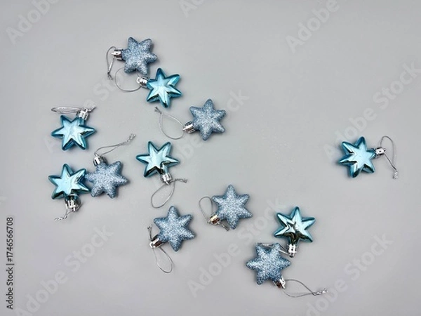 Obraz Blue Christmas star decorations scattered on a light surface, top view