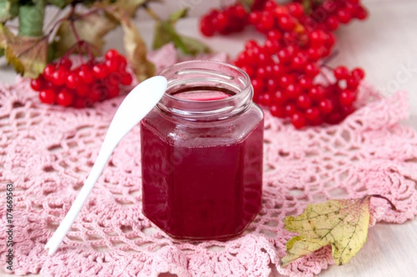 Fototapeta Jar of jam and berries of a viburnum on a table