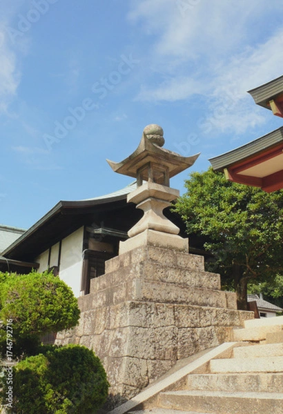 Fototapeta Big stone lantern at the entrance of the Japanese shrine.