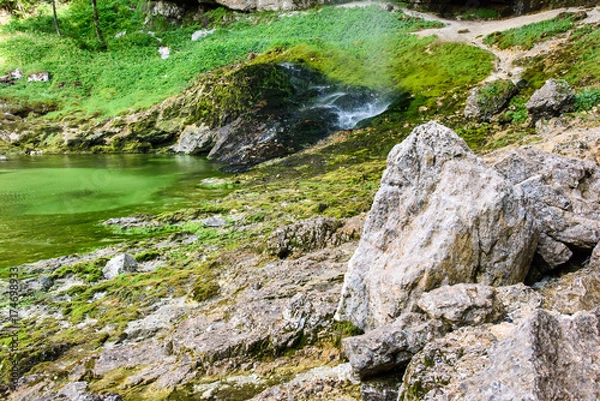 Fototapeta Dreamy waterfall and small emerald pond. Karst water. Fontanon of Goriuda. Friuli