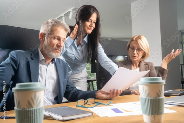 Fototapeta Multiethnic business people working together in the office. Corporate business team and manager in a meeting. Image of three business people working at meeting	
