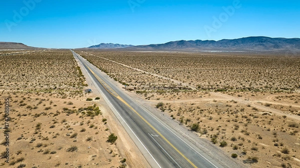 Fototapeta Aerial Nevada Desert Highway Vast Open Landscape and Distant Mountains