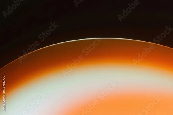 Fototapeta Vibrant Sunset Abstract: Capturing the mesmerizing dance of light and shadow, the image presents an abstract composition, showcasing the captivating fusion of warm orange hues and a sleek.