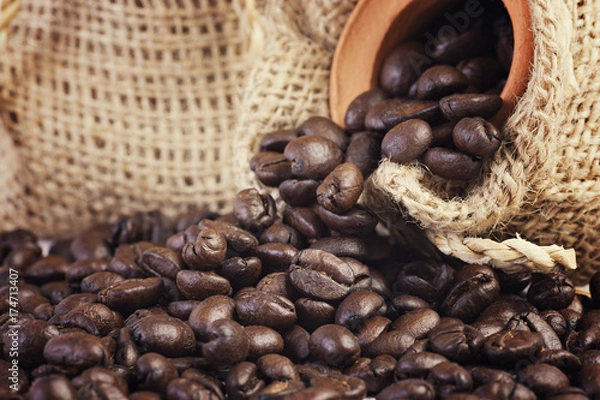 Obraz Roasted coffee beans in hemp sacks isolated on white background.