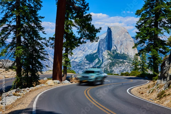 Fototapeta Yosemite Mountain Road Curve with Moving Car and Half Dome in Summer
