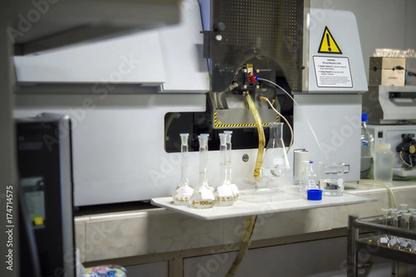 Fototapeta Scientists are using Atomic Absorption Spectroscopy (AAS) to analyze heavy metals in sample solutions.For example, element Pb, Fe, Mn, Ag, etc.