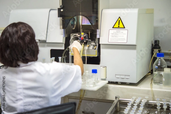 Fototapeta Scientists are using Atomic Absorption Spectroscopy (AAS) to analyze heavy metals in sample solutions.For example, element Pb, Fe, Mn, Ag, etc.