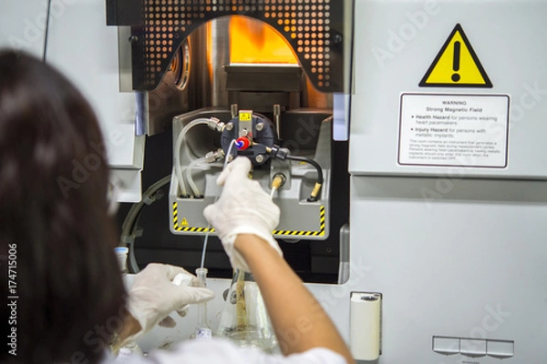 Fototapeta Scientists are using Atomic Absorption Spectroscopy (AAS) to analyze heavy metals in sample solutions.For example, element Pb, Fe, Mn, Ag, etc.