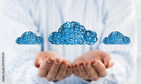 Fototapeta Man presenting in his palms cloud computing concept as mechanism of cogwheels