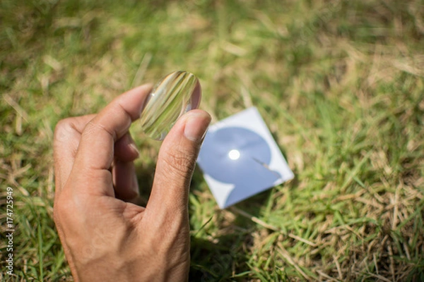 Fototapeta Merge sunlight with paper with a convex lens.