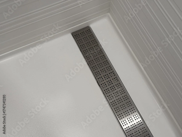 Fototapeta Modern white shower floor with stainless steel linear drain, clean geometric interior design emphasizing minimalism, symmetry, and contemporary bathroom architecture