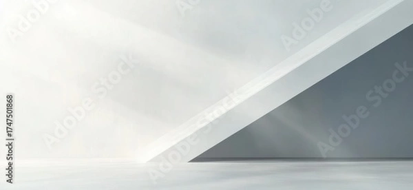 Fototapeta Minimalist empty interior space with white and gray angled walls and sunlight casting soft shadows on the floor