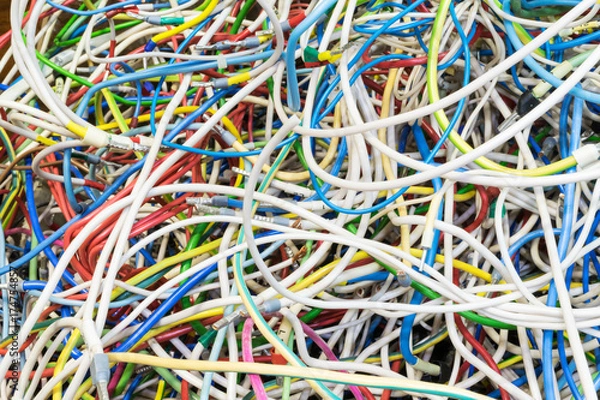 Fototapeta The bunch of electric wires of different colors are very much intertwined. On tangled wires is wire-end ferrules and markings. Chaos, confusion, tangle.