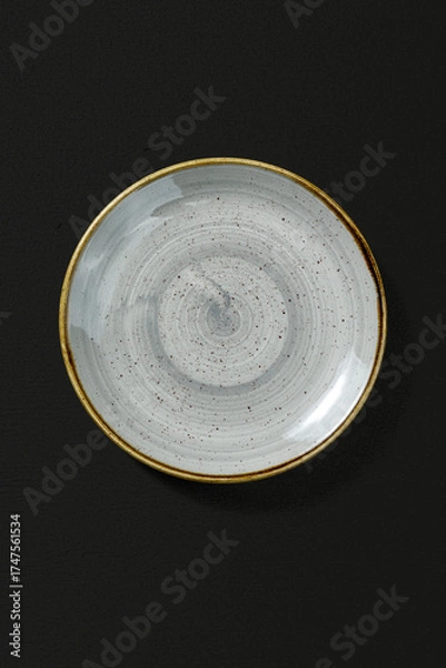 Obraz Ceramic plate on dark background