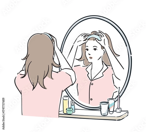 Obraz 鏡の前でヘアバンドを止めるパジャマ姿の女性

