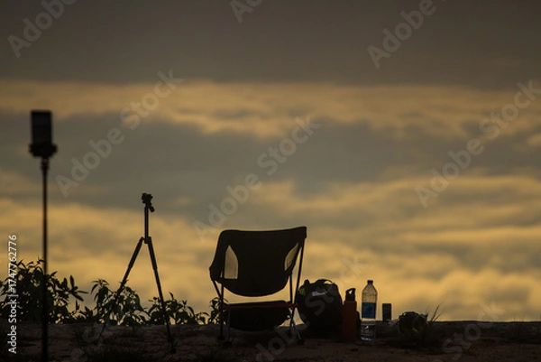 Fototapeta The garden chair is located on the edge of the cliff in the morning, with a sea of mist in the background.