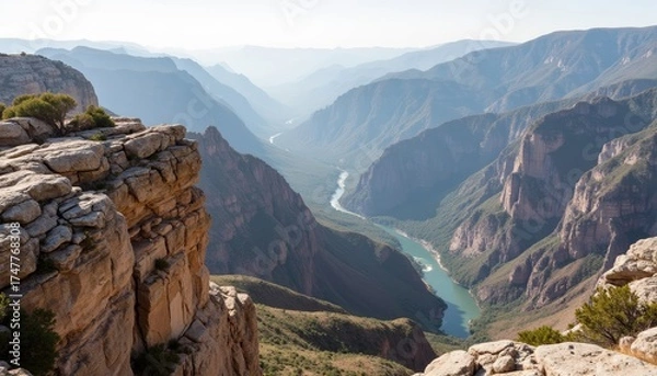 Obraz Scenic view of a canyon with a river running through the valley  