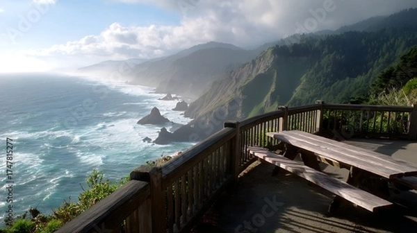Fototapeta A coastal overlook with a railing and benches, waves crashing against cliffs far below