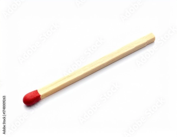 Fototapeta Single wooden matchstick with red-tipped head, placed diagonally on plain white background, sharp and minimal composition highlighting everyday object used for ignition and combustion.