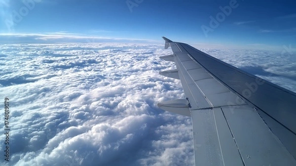 Obraz Wing View of Clouds from Airplane Travel Adventure Cloudscape Serenity Blue Sky
