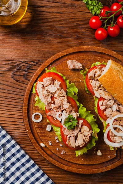 Fototapeta Delicious tuna sandwich, served with lettuce, tomato and onion.