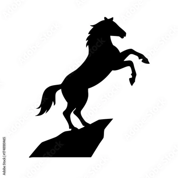 Fototapeta Black silhouette of a horse rearing on a rock