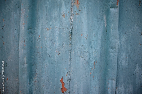 Obraz Weathered metal surface with grunge-style painted texture, showing rust patterns and peeling blue paint. Creates a gritty, corroded background — perfect for themes of decay or abandonment.