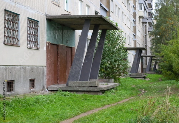 Obraz A path in the grass along a multi-storey building made of concrete panels, Iskrovsky Prospekt, Saint Petersburg, Russia, October 06, 2025