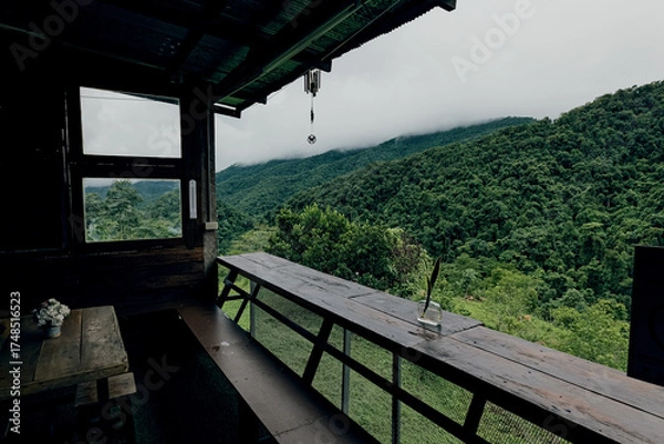 Fototapeta A viewpoint area with a roof and sitting area overlooking lush green jungle