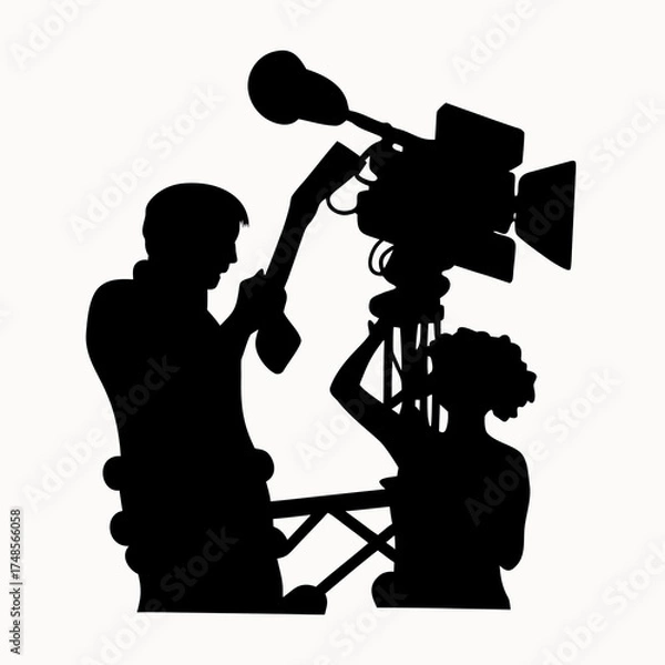 Fototapeta Silhouette of two people working with a large television camera on a tripod in a studio setting