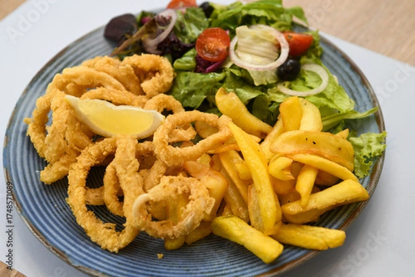 Fototapeta Fried squid rings with french fries and salad