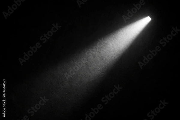 Fototapeta A solitary beam of light cuts through the darkness, illuminating a small area. The stark contrast between light and shadow creates a dramatic mood.AI generated.