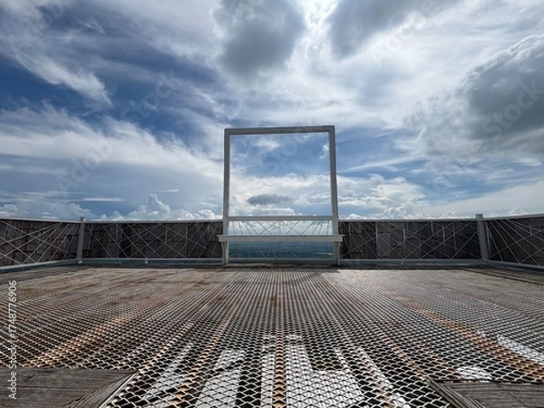 Fototapeta Window frame with cloudy blue sky in background