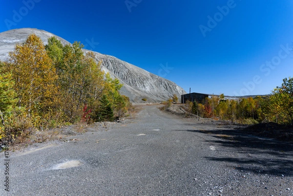 Obraz A mountain of mining wastes near a building