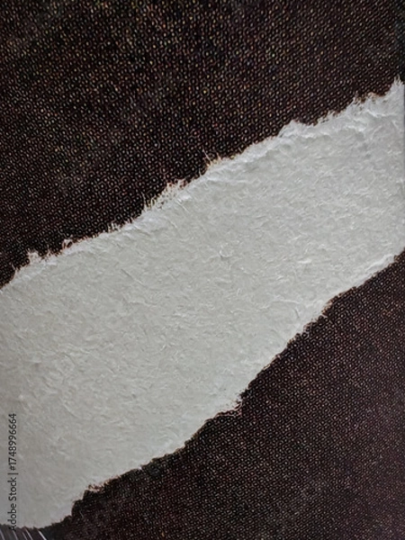 Fototapeta Close-up of torn paper edge with fibrous texture placed on a dark speckled background. Ideal for abstract design, texture studies, or creative compositions.