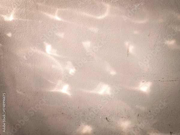 Obraz Soft light reflections cast abstract patterns on a textured cement wall. Ideal for backgrounds, design concepts, or artistic compositions with natural ambiance.