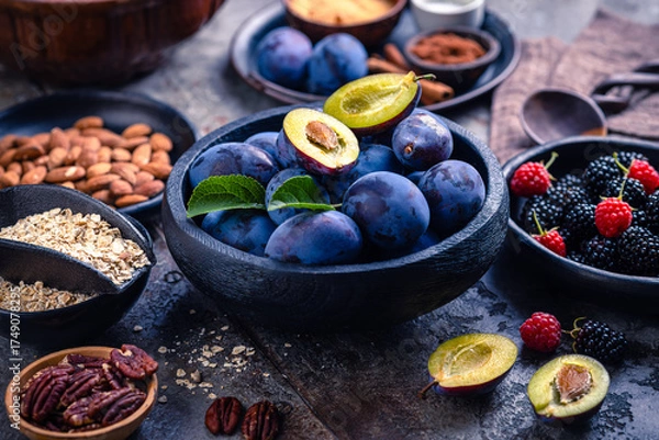 Obraz Freshly picked berries and plums with healthy baking ingredients