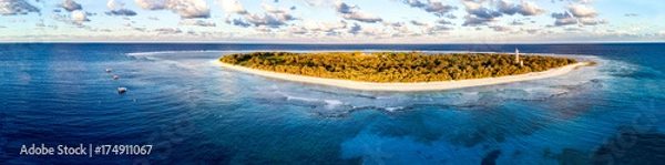 Fototapeta Aerial view of Lady Elliot Island in Queensland Australia with the coral reef in the foreground and clouds in the background.