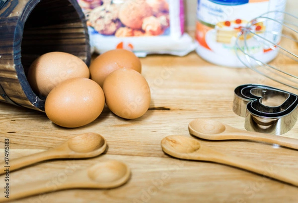 Obraz flour with egg and ingredients for homemade bakery on wooden background