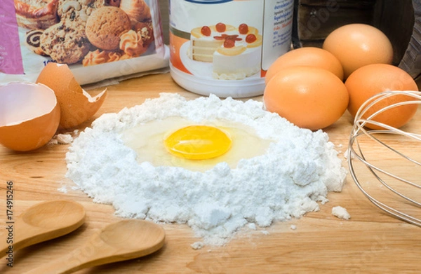 Obraz flour with egg and ingredients for homemade bakery on wooden background