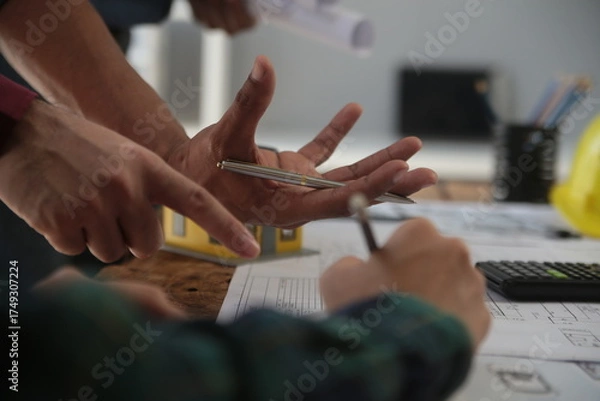 Fototapeta Diverse Team of Specialists Use Laptop on Construction Site. Real Estate Building Project with Engineer Investor and Businessman Checking Area, working on Civil Engineering, Discussing Strategy Plan