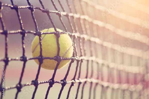 Obraz Tennis ball hitting the tennis net at tennis court with copy space.