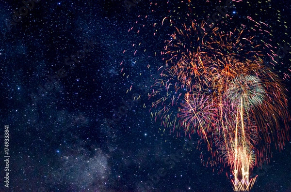 Fototapeta Fireworks with blur milky way background
