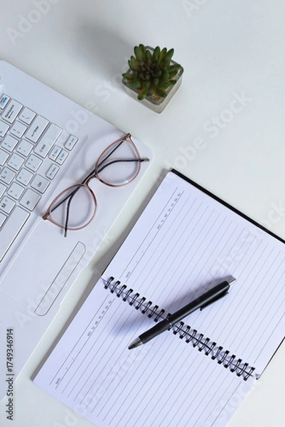 Fototapeta Professional Workspace Essentials Laptop Notebook Pen Glasses