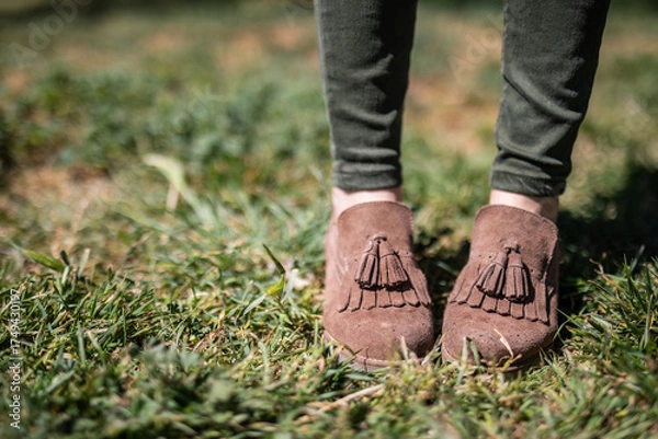 Obraz Stylish suede moccasins with tassels stand out against the green grass, perfect for lifestyle blog or fashion magazine promoting fall trends