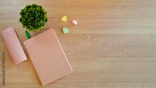 Fototapeta On the wooden surface of the table there is a notebook with a pen and elastic bands